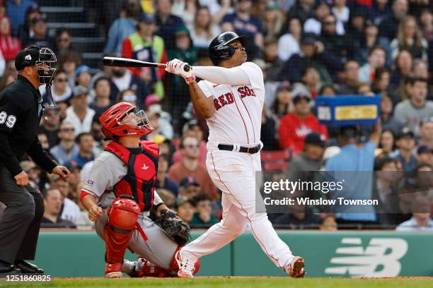 Rafael Devers of the Boston Red Sox watches his two-run home run against the Los Angeles Angels during the first inning at Fenway Park on April 15,...