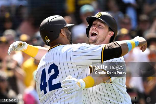 Jake Cronenworth of the San Diego Padres is hugged by Nelson Cruz after hitting a two-run home run during the fifth inning of a baseball game against...