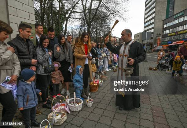 Father Bohdan Kryk presides over a food blessing ceremony outside the Dormition of the Virgin Mary Greek Catholic parish, in Rzeszow, Poland, on...