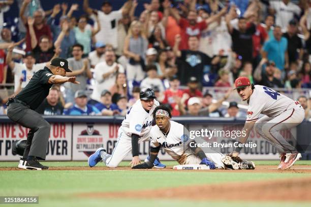 Jean Segura of the Miami Marlins is called safe at third base during the seventh inning of the game against the Arizona Diamondbacks at loanDepot...