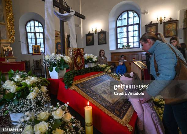 Young worshipper kisses the Holy Shroud during the Holy Saturday service at the Dormition of the Virgin Mary Greek Catholic parish, in Rzeszow,...