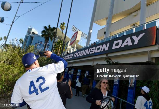 Fans take souvenir photos as they arrive to the start of the game between the Chicago Cubs and the Los Angeles Dodgers on Jackie Robinson Day at...