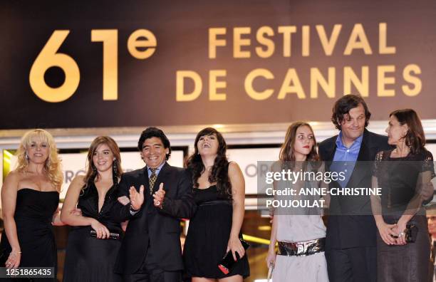 Former Argentinian football player Diego Maradona applauds as he arrives with his wife Claudia and daughters Dalma and Giannina , Serbian director...