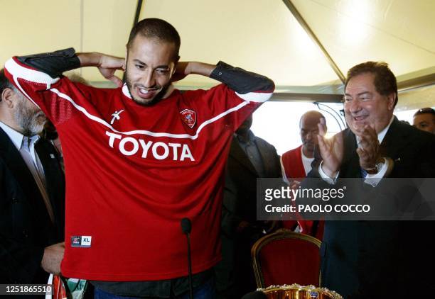 Saadi Kadhafi , son of Libyan leader Moamar Kadhafi, tries on his new Perugia soccer team jersey as the Italian team's president Luciano Gaucci...