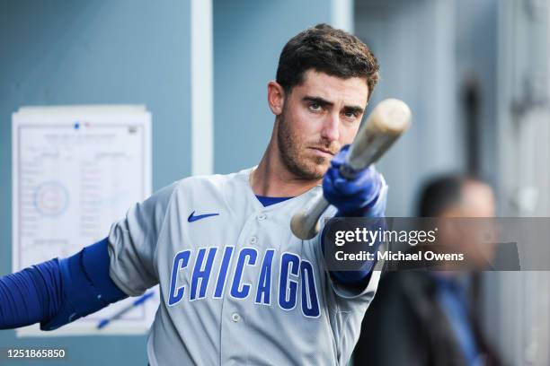 Cody Bellinger of the Chicago Cubs warms up in the dugout in the first inning during the game between the Chicago Cubs and the Los Angeles Dodgers at...