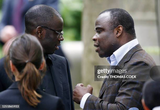 French national football team player Lilian Thuram speaks with former football player Basile Boli , 10 May 2007 at the Luxembourg gardens in Paris,...