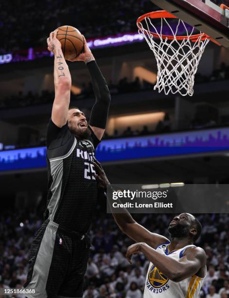 Alex Len of the Sacramento Kings dunks over Draymond Green of the Golden State Warriors during the second quarter of Round 1 Game 1 of the 2023 NBA...
