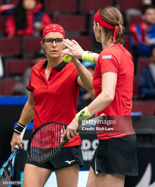 Kirsten Flipkens and Greet Minnen of Belgium celebrate a point during their doubles match against Leylah Annie Fernandez and Gabriela Dabrowski of...