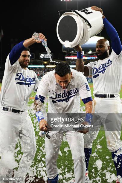 David Peralta of the Los Angeles Dodgers receives a Gatorade bath from teammates after hitting a walk-off two RBI single in the ninth inning during...
