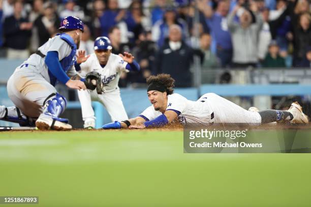 Miguel Vargas of the Los Angeles Dodgers scores off a walk-off two RBI single by David Peralta in the ninth inning during the game between the...
