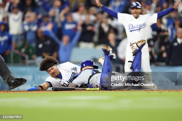 Miguel Vargas of the Los Angeles Dodgers scores off a walk-off two RBI single by David Peralta in the ninth inning during the game between the...