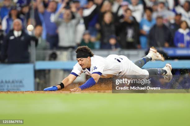 Miguel Vargas of the Los Angeles Dodgers scores off a walk-off two RBI single by David Peralta in the ninth inning during the game between the...