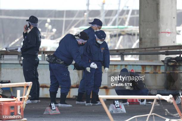 Police officers investigate Saikazaki port, where Japan's Prime Minister Fumio Kishida was evacuated unharmed from the scene of an apparent "smoke...