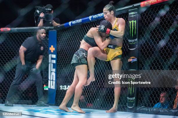 Denise Gomes clenches Bruna Brasil against the cage in a strawweight bout during UFC Fight Night Kansas City on April 15 at T-Mobile Center in Kansas...