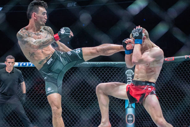 Max Holloway kicks Arnold Allen in a featherweight bout during UFC Fight Night Kansas City on April 15 at T-Mobile Center in Kansas City, Missouri.