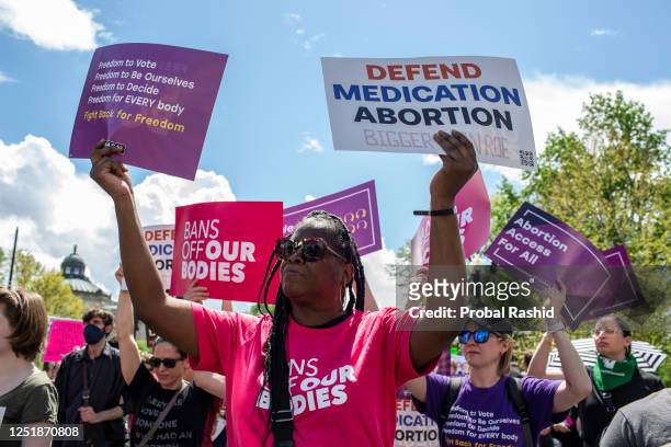 Activists holding abortion rights signs shout slogans during a rally. Abortion rights activists rallied outside the US Supreme Court in Washington,...