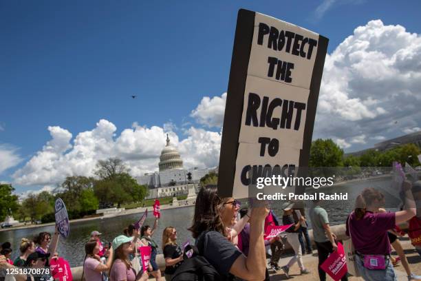 An abortion rights activist holds a sign with "Protect The Right To Choose" written on it while joining in a rally in support of the abortion rights....