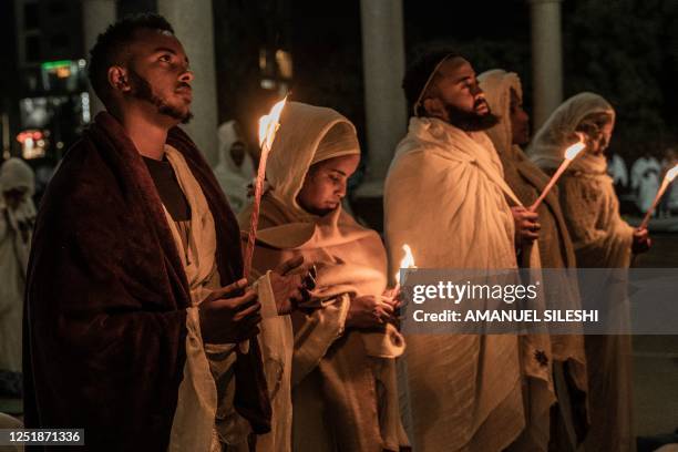 Ethiopian Orthodox devotees pray as they hold candles during the celebration of Easter at Bole Medhanialem church in Addis Ababa, Ethiopia on April...