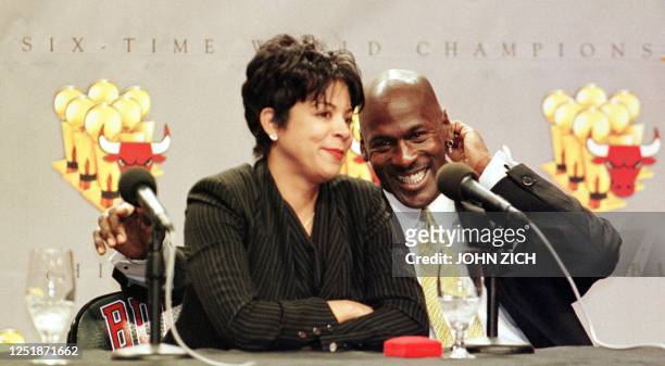 Michael Jordan of the Chicago Bulls laughs as his wife Juanita is questioned by reporters about how her life will change with Michael Jordan's...