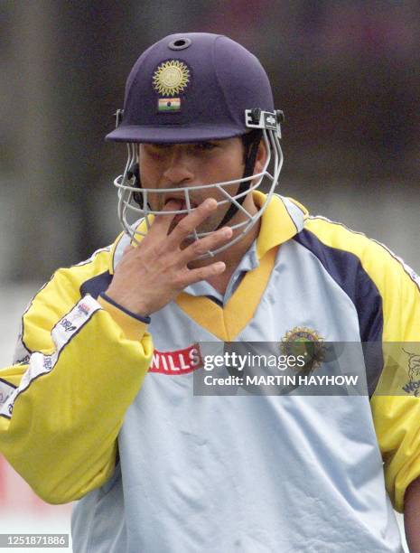 Indian Sachin Tendulkar sucks his finger after receiving a blow on the hand during a practice session 03 June 1999 at the Oval in London, prior to...