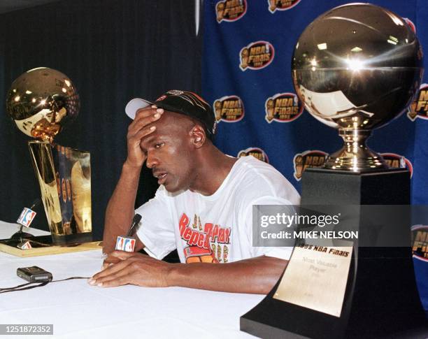 Michael Jordan of the Chicago Bulls talks to the media 14 June after winning game six of the NBA Finals against the Utah Jazz at the Delta Center in...