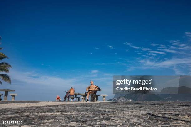 Retired man enjoys a sunny morning at Arpoador beach.