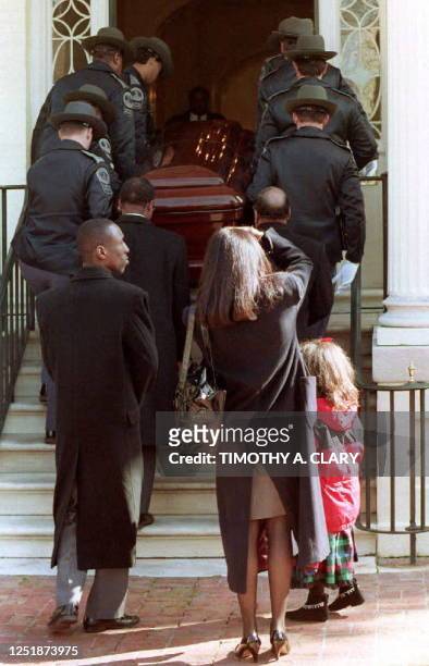 Members of the Virginia State Police carry the casket containing the body of tennis great Arthur Ashe into the Governor's Mansion 09 February, 1993....
