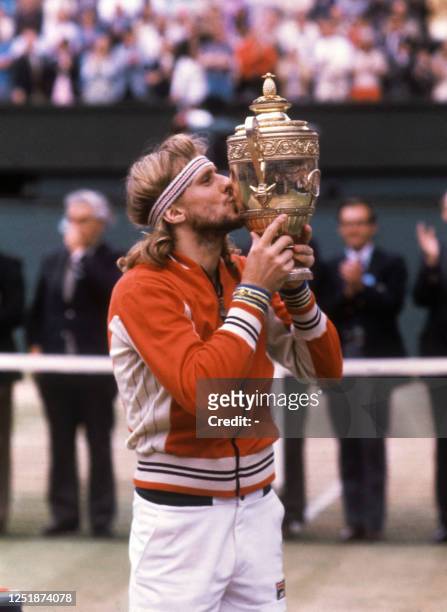 Swedish tennis player Björn Borg kisses the trophy after winning the Wimbledon singles championship for the fifth time in London in July 1980. Born...