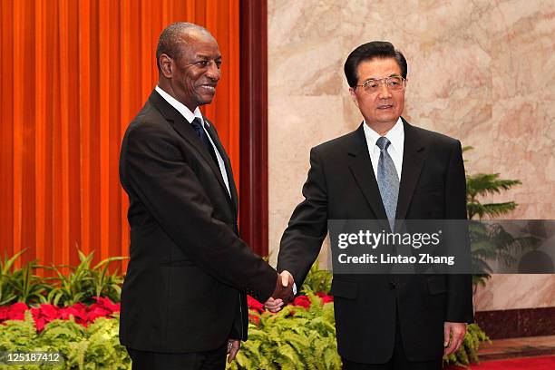 Guinea President Alpha Conde shakes hands with Chinese President Hu Jintao at the Great Hall of People on September 16, 2011 in Beijing, China....