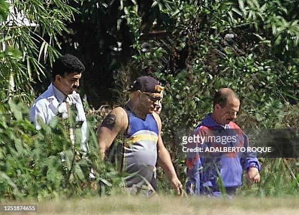 Former Argentine soccer star Diego Maradona takes a walk with doctors around the Las Praderas hotel in Havana where he is under treatment for drug...