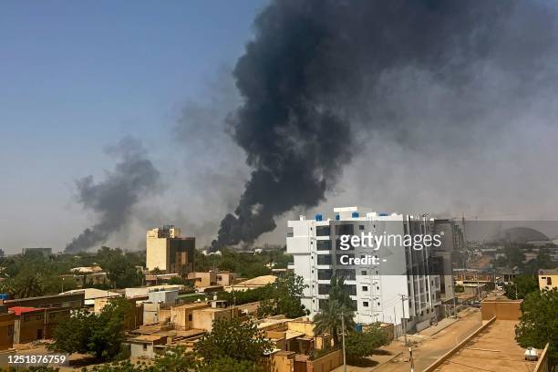 Smoke billows above residential buildings in Khartoum on April 16 as fighting in Sudan raged for a second day in battles between rival generals....