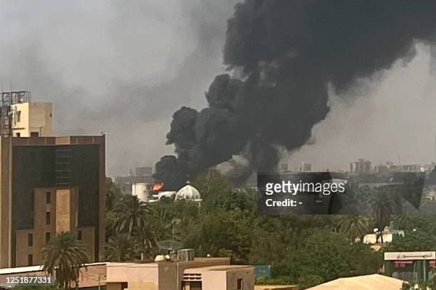 Smoke billows above residential buildings in Khartoum on April 16 as fighting in Sudan raged for a second day in battles between rival generals....