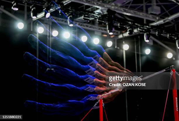 This multi-exposure photograph shows Italy's Carlo Macchini competing in the Men's high bar apparatus final event during the Artistic Gymnastics...