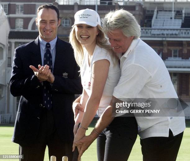 Former Australian fast bowler Jeff Thomson helps model Emma Noble with a forward stroke as England's cricket captain Nasser Hussain applauds 24...