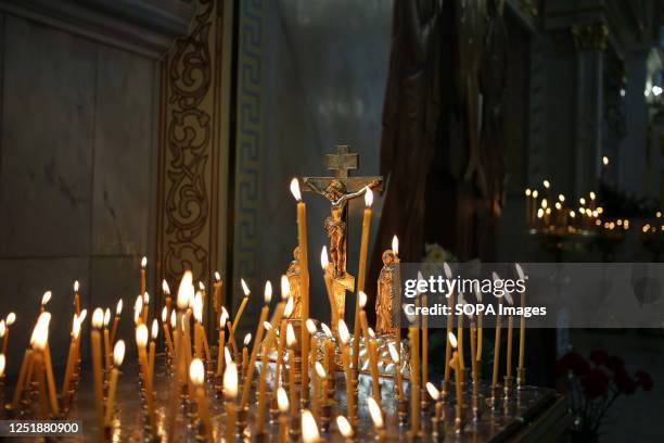 The crucifix with the body of Jesus Christ and burning candles are visible. Easter celebration at the Transfiguration Cathedral to celebrate the...