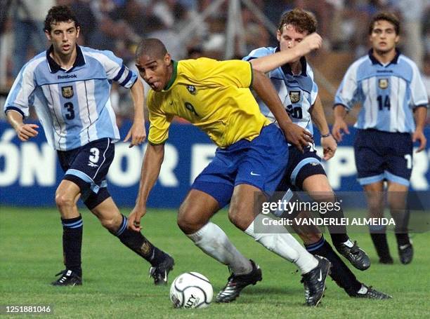 Brazilian player Adriano and Argentinian players Julio Arca and Mauro Cetto fight for the ball during a game counting towards the Southamerican...