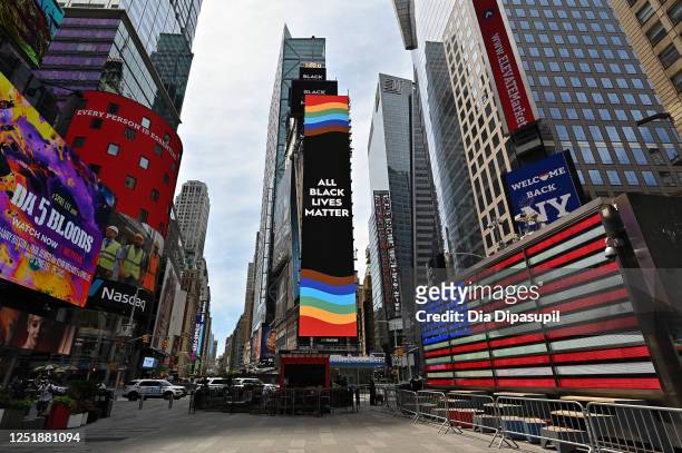 Billboards light up with 'All Black Lives Matter' message and a Pride flag in Times Square on June 24, 2020 in New York City. Due to the ongoing...