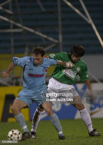 S Mirko Grabovac pushes away Geylang United's Robin Chitrakar and gains possession of the ball during a Singapore Cup match in Singapore, 22...