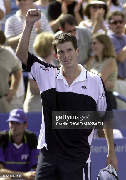 Tim Henman of Great Britain pumps his fist as he acknowledges the crowd's applause following his victory over Brazilian player Gustavo Kuerten 12...