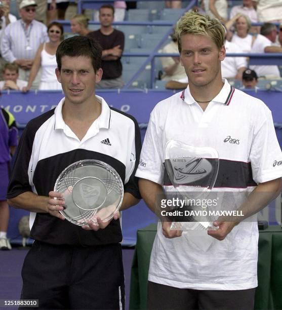 Tim Henman of England and Thomas Enqvist of Sweden hold their trophies during the awards ceremony 13 August 2000 at the 2000 Tennis Masters Series...
