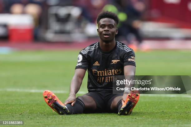 Bukayo Saka of Arsenal looks dejected during the Premier League match between West Ham United and Arsenal FC at London Stadium on April 16, 2023 in...