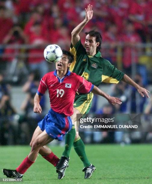 South Korean Lee Young-Pyo and Australia's Aurelio Vidmar fights for the ball 03 June 2001 during the first group A match of the FIFA Confederation...