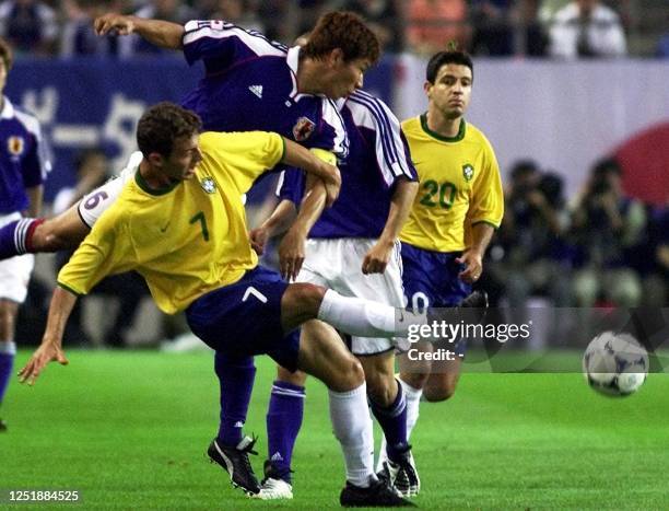 Japanese player Toshihiro Hattori and Leandro of Brazil battle for the ball during their FIFA's Confederations Cup match in Kashima, 100km north of...
