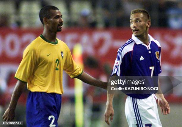 Japanese player Hidetoshi Nakata is congratulated by Maria Ze of Brazil after their FIFA's Confederations Cup match in Kashima, 100km north of Tokyo,...