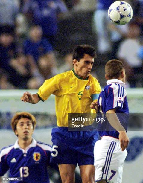 Brazilian captain Leomar and Hidetoshi Nakata fight for the ball while Yoshiteru Yamashita looks on during their FIFA's Confederations Cup match in...