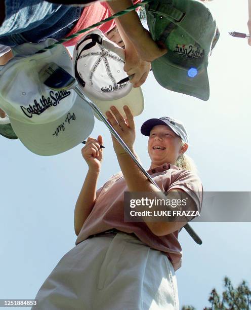 Amateur golfer Morgan Pressel of the US, signs autographs during a practice round 30 May, 2001 at the US Women's Open at Pine Needles Lodge and Golf...