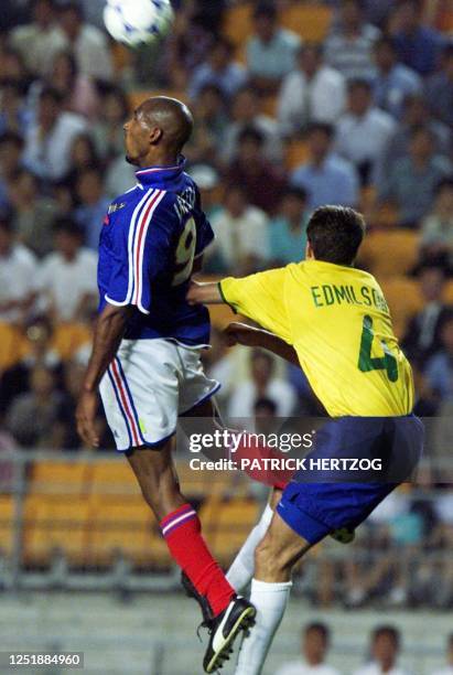 France's Nicolas Anelka struggles for the ball with Brazil's Edmilson during the semi-final of the FIFA's Confederations Cup match between France and...