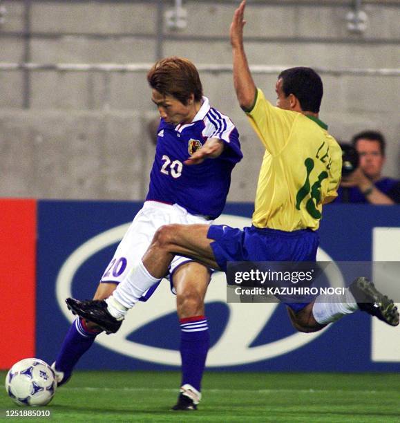 Brazilian player Leo and Yasuhiro Hato of Japan battle for the ball during their FIFA's Confederations Cup match in Kashima, 100 km north of Tokyo,...