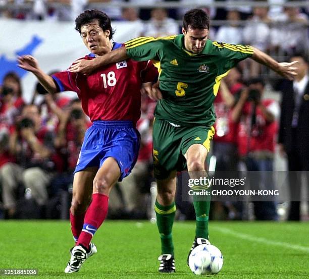 Australia's Tony VidmAr struggles for the ball with South Korea's Hwang Sun-Hong during the FIFA ConfederationS Cup in Suwon city, some 46 KmS south...