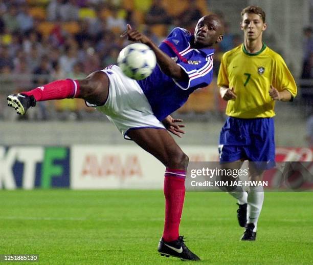 France's Patrick Vieira kicks the ball ahead of Brazil's Leandro during the semi-final of the FIFA's Confederations Cup match between France and...